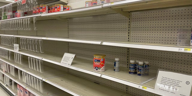 Empty formula shelves are shown in a Target store in Long Island, New York.