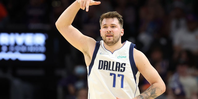 Luka Doncic #77 of the Dallas Mavericks reacts after making a three point basket during the third quarter against the Phoenix Suns in Game Seven of the 2022 NBA Playoffs Western Conference Semifinals at Footprint Center on May 15, 2022 in Phoenix, Arizona.