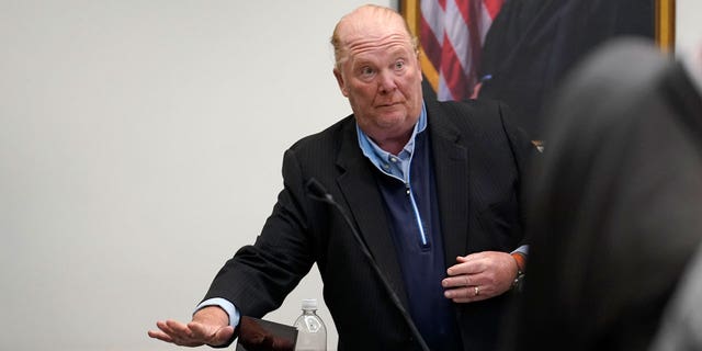 Batali places items on a table in Boston Municipal Court.