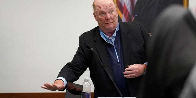 Batali places items on a table in Boston Municipal Court.