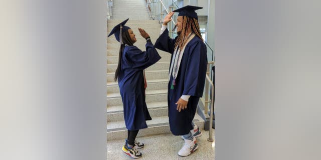 Dual-enrolled high school student SaNayah Hill (left) earned a career studies certificate in emergency medical service from Tidewater Community College — while her father Marvin Fletcher (right) earned his associate of applied science in management.