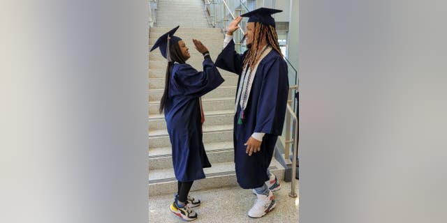 Dual-enrolled high school student SaNayah Hill (left) earned a career studies certificate in emergency medical service from Tidewater Community College — while her father Marvin Fletcher (right) earned his associate of applied science in management.