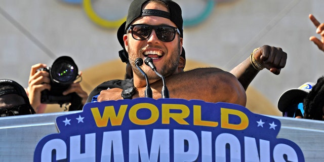 Rams quarterback Matthew Stafford celebrates their Super Bowl championship in front of the Coliseum Wednesday.