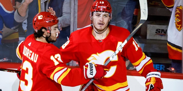 Calgary Flames forward Matthew Tkachuk, right, celebrates his goal against the Edmonton Oilers with forward Johnny Gaudreau during the second period of Game 1 of an NHL hockey second-round playoff series Wednesday, May 18, 2022, in Calgary, Alberta.