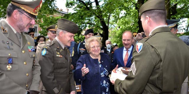 Hundreds of people gathered to celebrate Meri Mion's 90th birthday in Italy. Sgt. Peter Wallis, a military police officer, presented her with a special cake that the U.S. Army garrison Italy ordered for her on Thursday, April 28, 2022.