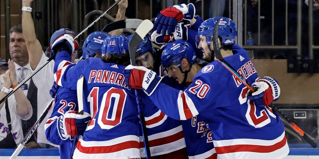New York Rangers' Mika Zibanejad is congratulated by teammates after scoring a goal against the Carolina Hurricanes in Game 3 of an NHL hockey Stanley Cup second-round playoff series, Sunday, May 22, 2022, in New York.