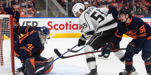 Los Angeles Kings' Quinton Byfield (55) is stopped by Edmonton Oilers goalie Mike Smith (41) as Kailer Yamamoto (56) defends during the first period of Game 2 of an NHL hockey Stanley Cup playoffs first-round series Wednesday, May 4, 2022, in Edmonton, Alberta. 