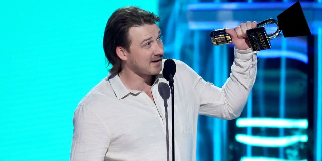 Morgan Wallen accepts an award at the 2022 Billboard Music Awards.