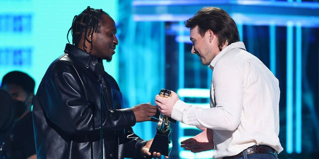 Pusha T presents an award to Morgan Wallen at the 2022 Billboard Music Awards.