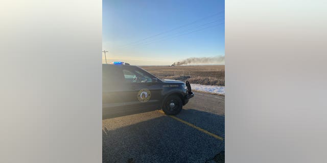Wet fields caused by recently melted snow make it hard for emergency crews to get to the scene.