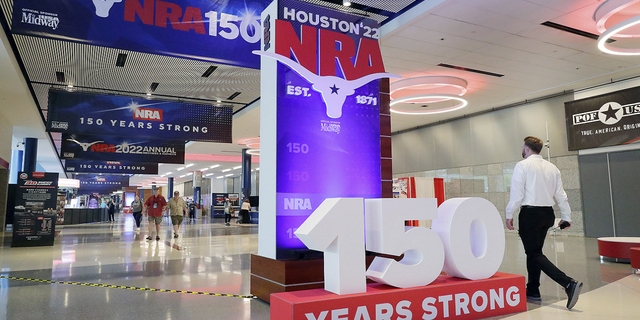 People attend the NRA's annual meeting at the George R. Brown Convention Center in Houston.