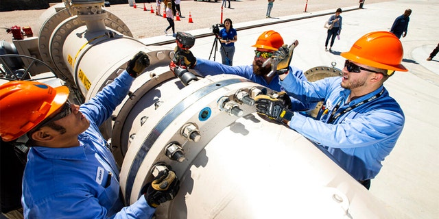 Southern Nevada Water Authority maintenance mechanics, from left, Jason Dondoy, Patrick Smith and Tony Mercado install a spacer flange after removing an energy dissipator at the Low Lake Level Pumping Station (L3P3) at Lake Mead National Recreation Area on Wednesday, April 27, 2022, outside of Las Vegas. 