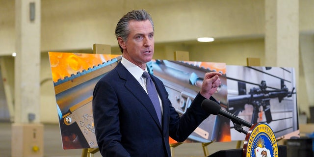 California Gov. Gavin Newsom, along with several elected officials, meets with the media at Del Mar Fairgrounds on Feb. 18 where he backed state legislation that would allow for private citizens to enforce the state's ban on assault weapons. A U.S. appeals court ruled Wednesday that California’s ban on the sale of semiautomatic weapons to adults under 21 is unconstitutional.  