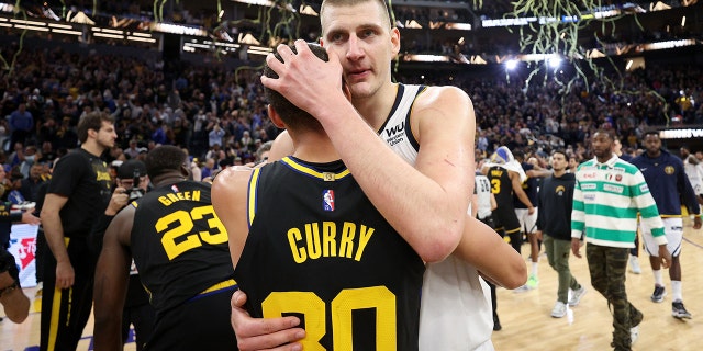 Stephen Curry #30 of the Golden State Warriors hugs Nikola Jokic #15 of the Denver Nuggets after Game Five of the Western Conference First Round NBA Playoffs at Chase Center on April 27, 2022 in San Francisco, California.