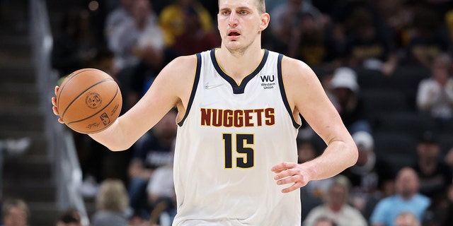 Nicola Jokic of Denver Nuggets dribbles the ball against the pacers at Gainbridge Fieldhouse in Indianapolis on March 30, 2022.