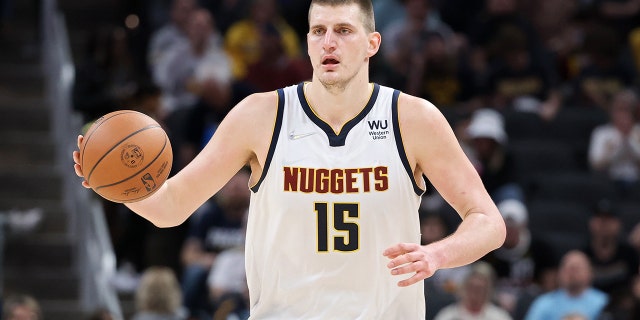 Nikola Jokić of the Denver Nuggets will dribble the ball against the Indiana Pacers in the third quarter at the Gainbridge Fieldhouse in Indianapolis on March 30, 2022.