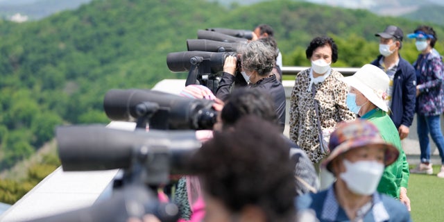 Visitors use binoculars to see the North Korean side from the unification observatory in Paju, South Korea, Thursday, May 12, 2022. (G3 Box News Photo/Lee Jin-man)