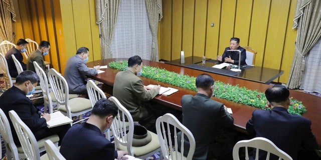 In this photo provided by the North Korean government, North Korean leader Kim Jong Un, top, visits state emergency epidemic prevention headquarters in North Korea Thursday, May 12, 2022. 