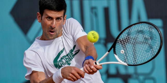 Novak Djokovic returns the ball during a training session at the Mutua Madrid Open in Spain, April 30, 2022.