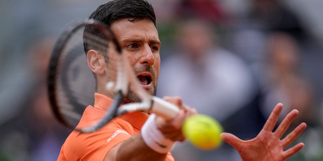 Serbia's Novak Djokovic returns the ball against Gael Monfils, of France, during their match at the Mutua Madrid Open tennis tournament in Madrid, Spain, Tuesday, May 3, 2022.