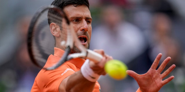 Serbia's Novak Djokovic returns the ball against Gael Monfils, of France, during their match at the Mutua Madrid Open tennis tournament in Madrid, Spain, Tuesday, May 3, 2022.