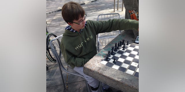 This young person learned how to play chess when he was four years old. 