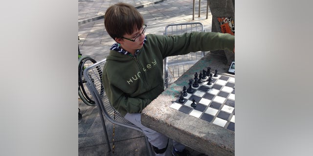 This young person learned how to play chess when he was four years old.