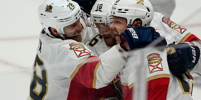 Florida Panthers right wing Claude Giroux (28), center Aleksander Barkov (16) and center Sam Reinhart, right, celebrate Reinhart's goal in the third period of Game 4 in the first round of the NHL Stanley Cup hockey playoffs against the Washington Capitals, Monday, May 9, 2022, in Washington.