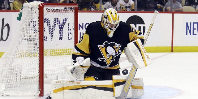 May 13, 2022; Pittsburgh, Pennsylvania, USA; Pittsburgh Penguins goaltender Louis Domingue (70) makes a save against the New York Rangers during the third period in game six of the first round of the 2022 Stanley Cup Playoffs at PPG Paints Arena. The Rangers won 5-3. Mandatory Credit: Charles LeClaire-USA TODAY Sports