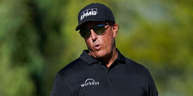Phil Mickelson reacts after missing a putt from just off the 18th hole during the first round of the Charles Schwab Cup Championship golf tournament in Phoenix, Ariz., Nov 11, 2021.