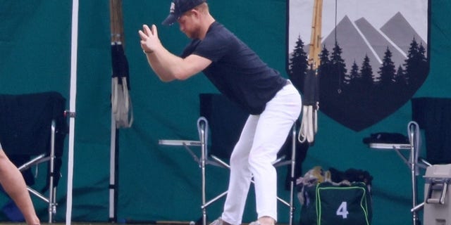 Prince Harry enjoys a deep stretch before a polo match in Santa Barbra.