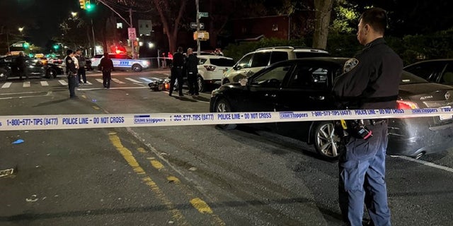 Authorities in Queens secure the scene near Zhiwen Yan's scooter where he was shot and killed.