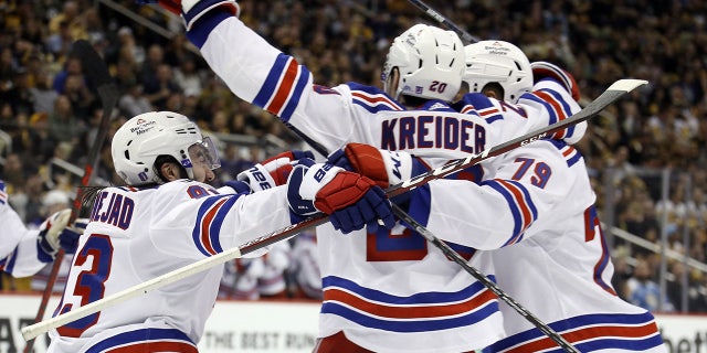 May 13, 2022; Pittsburgh, Pennsylvania, USA; The New York Rangers celebrate the game winning goal scored by Rangers left wing Chris Kreider (20) against the Pittsburgh Penguins during the third period in game six of the first round of the 2022 Stanley Cup Playoffs at PPG Paints Arena. The Rangers won 5-3. Mandatory Credit: Charles LeClaire-USA TODAY Sports