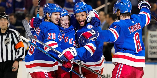 New York Rangers' Chris Kreider (20) celebrates with teammates K'Andre Miller (79) and Jacob Trouba (8) after scoring a goal during the second period of Game 2 of an NHL hockey Stanley Cup first-round playoff series against the Pittsburgh Penguins, Thursday, May 5, 2022, in New York.