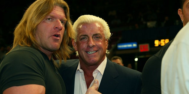 WWE wrestlers Triple H and Ric Flair attend the New York Knicks-Boston Celtics game March 9, 2004, at Madison Square Garden.