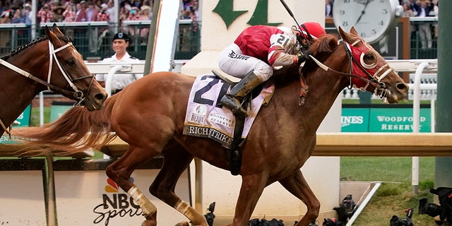 Rich Strike (21), with Sonny Leon aboard, crosses the finish line to win the 148th running of the Kentucky Derby horse race at Churchill Downs Saturday, May 7, 2022, in Louisville, Ky.