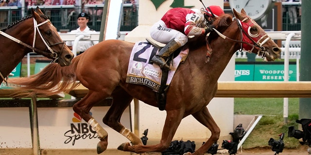 Rich Strike (21), with Sonny Leon aboard, crosses the finish line to win the 148th running of the Kentucky Derby horse race at Churchill Downs Saturday, May 7, 2022, in Louisville, Ky.