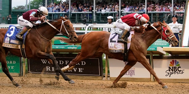 Rich Strike (21), with Sonny Leon aboard, beats Epicenter (3), with Joel Rosario aboard, at the finish line to win the 148th running of the Kentucky Derby horse race at Churchill Downs Saturday, May 7, 2022, in Louisville, Ky.