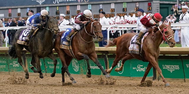Rich Strike, with Sonny Leon aboard, leads Epicenter and Zandon down the straightaway to win the 148th running of the Kentucky Derby at Churchill Downs Saturday, May 7, 2022, in Louisville. 