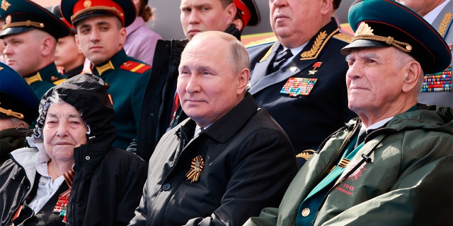 Russian President Vladimir Putin, center, attends the Victory Day military parade marking the 77th anniversary of the end of World War II 