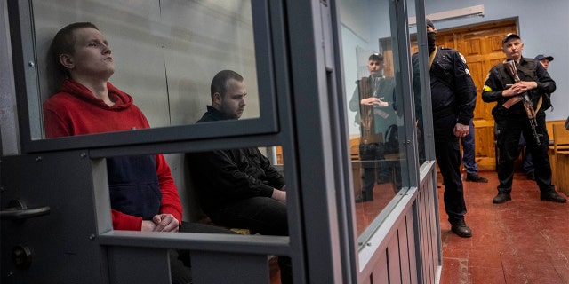Russian soldiers Alexander Alexeevich Ivanov and Alexander Vladimirovich Bobykin, left, attend their trial hearing in Kotelva, northeastern Ukraine, Thursday, May 26, 2022. (G3 Box News Photo/Bernat Armangue)