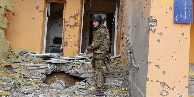 A Ukrainian service member shows a kindergarten damaged by a military strike in Sievierodonetsk, Luhansk region, Ukraine, on April 16, 2022.