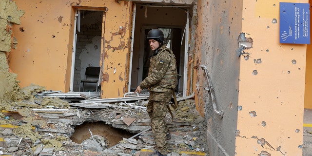 A Ukrainian service member shows a kindergarten damaged by a military strike in Sievierodonetsk, Luhansk region, Ukraine, on April 16, 2022.