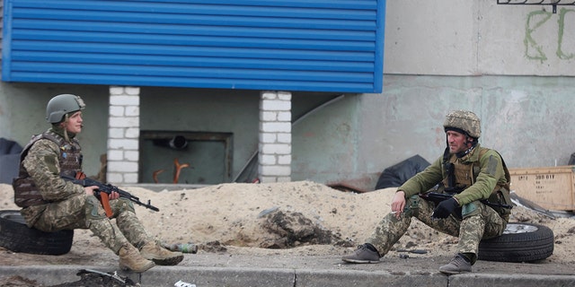 Ukrainian service members rest on a street, as Russia's attack on Ukraine continues, in Sievierodonetsk, Luhansk region, Ukraine April 16, 2022. 