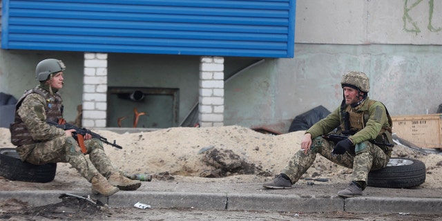 Ukrainian service members rest on a street, as Russia's attack on Ukraine continues, in Sievierodonetsk, Luhansk region, Ukraine April 16, 2022.