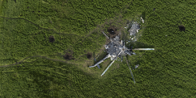 The remains of a destroyed Russian helicopter lie in a field in the village of Malaya Rohan, in the Kharkiv region of Ukraine, on May 16.