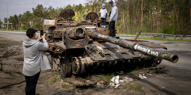 Maksym, 3, is pictured with his brother, Dmytro, 16, atop a destroyed Russian tank on the outskirts of kyiv, Ukraine, May 8.