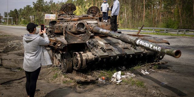 Maksym, 3, is photographed with his brother, Dmytro, 16, on top of a destroyed Russian tank, on the outskirts of Kyiv, Ukraine, on May 8.