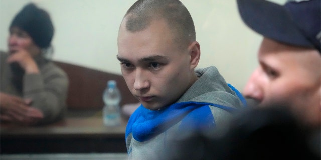 Russian army Sgt. Vadim Shishimarin, 21, is seen behind a glass during a court hearing in Kyiv, Ukraine, on Wednesday, May 18. He has been sentenced to life in prison for the killing of an unarmed civilian.