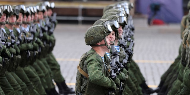 Russian servicemen march during a military parade marking the 77th anniversary of the victory over Nazi Germany in World War II, in Red Square in central Moscow on May 9, 2022.